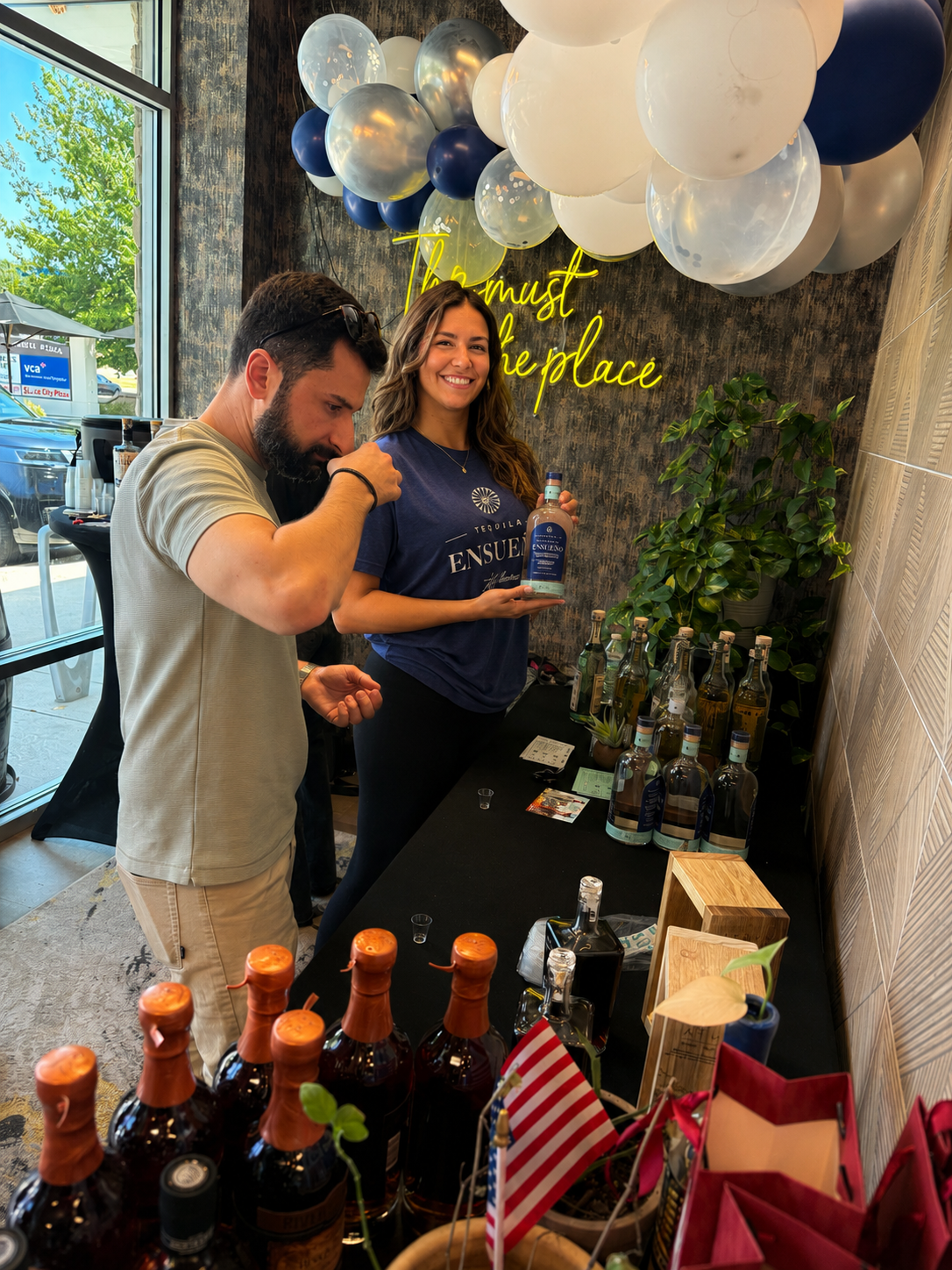 N.O.I.R. specialist introducing Terra Ensueño tequila to a guest at an activation