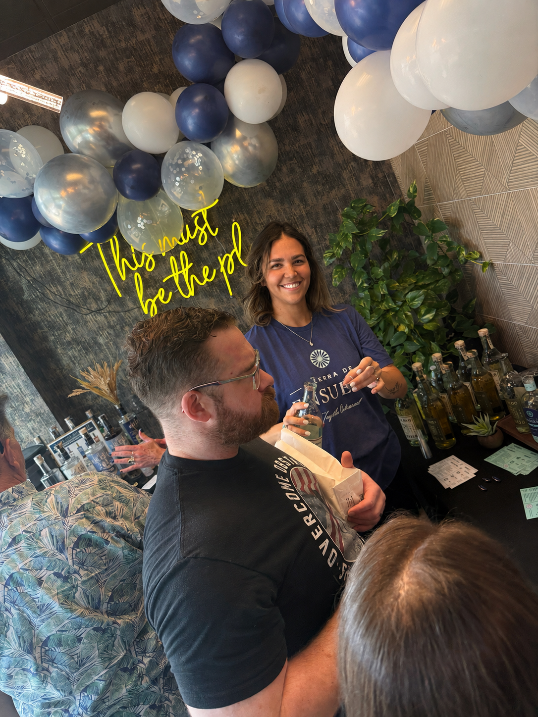 N.O.I.R. specialist speaking with guests during an Terra Ensueño Tequila activation